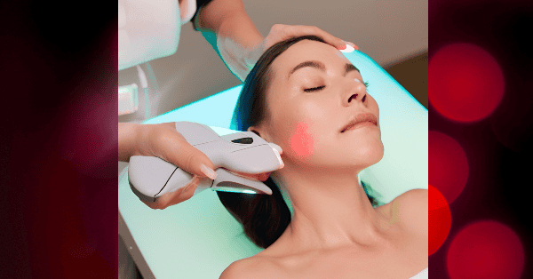 a woman getting light therapy treatment on face