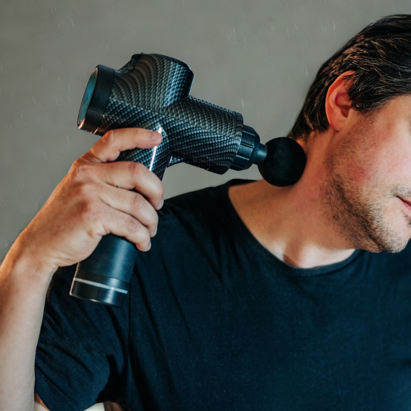 Massage gun used for deep tissue muscle recovery and relieving soreness after workouts