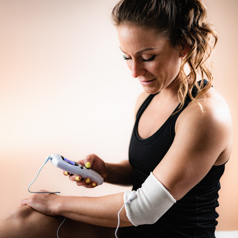 TENS unit device used for muscle recovery and natural pain relief therapy at home